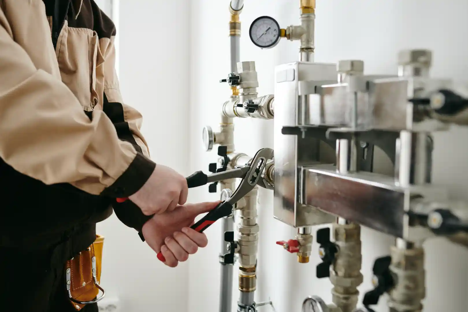 Licensed plumber in San Diego CA fixing valves and plumbing connections