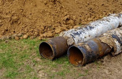 Exposed underground pipes damaged by soil shifts and valley heat in San Diego County.