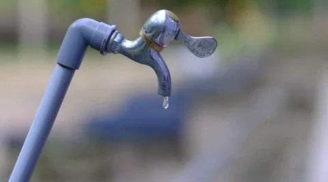 Low water pressure dripping from an outdoor spigot due to pipe corrosion.