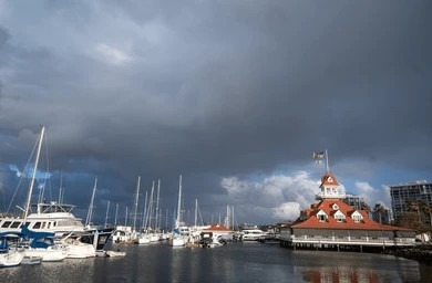 Dark storm clouds over San Diego harbor and marina boats before heavy rainfall.