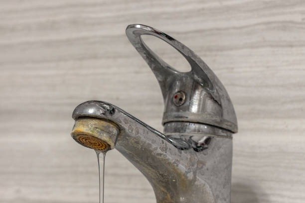 Close up of a metal faucet showing severe hard water damage and mineral buildup in San Diego.